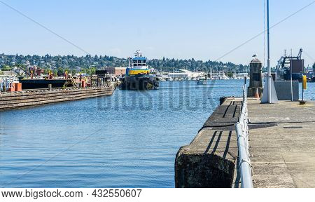 A Pier And Tugboat At The Ballard Locks In Washington State.