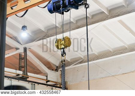 Chains For Lifting Loads On A Telpher Crane In A Workshop At A Factory.