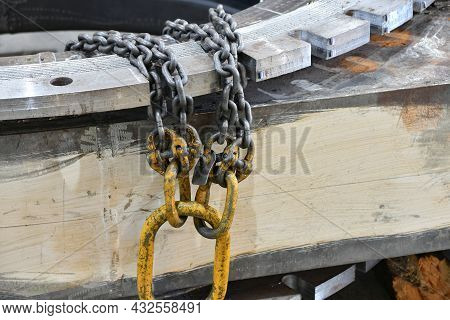 Chains For Lifting Loads On A Telpher Crane In A Workshop At A Factory.