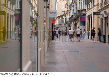 Málaga, Spain - June 19, 2021: People Walking In The Historic Center Of Malaga In Spain