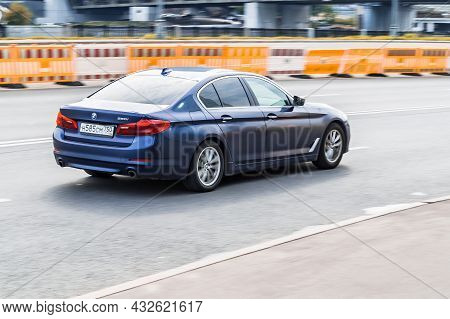 Moscow, Russia - August 2021: Rear Side View Of Bmw 5 Series In Motion. Blue Car Moving On The Stree