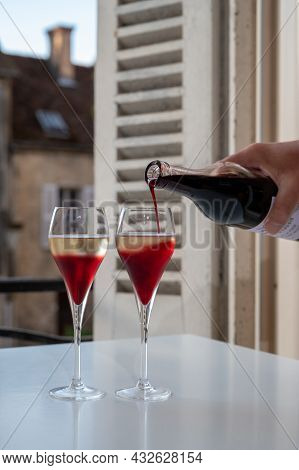 Drinking Of Kir Royal,  French Aperitif Cocktail Made  From Creme De Cassis Topped With Champagne, T