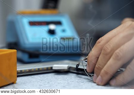 Wires Being Soldered Together With A Soldering Iron. Melting Solder Wire On Soldering Iron Tip