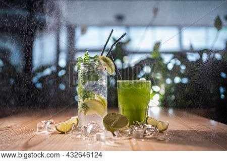 Mojito With Mint, Lime And Ice In Glass And Green Tarkhun Tarragon Drink In Cafe