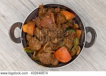 Overhead View Of Bhuna Flavored Lamb Meat In A Bowl From Indian Restaurant Cooked And Seasoned Perfe