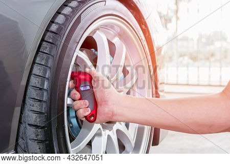 Close Up Tire Gauge Digital And Hand A Man Use For Check Air Pressure Of Wheel Car Basic Maintenance