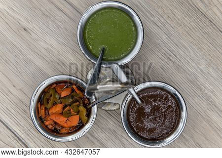 Overhead View Of Flavor Enhancing Condiments With Silver Serving Spoon And Round Cannisters For Easy