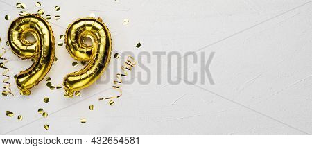 Golden Foil Balloon Number Ninety Nine. Birthday Or Anniversary Card With The Inscription 99. Gray C