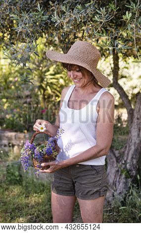Woman And Wild Flower In Basket For Naturopathy And Botany