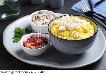 Tasty Banosh Served With Brynza, Pork Cracklings And Mushrooms On Dark Table. Traditional Ukrainian 