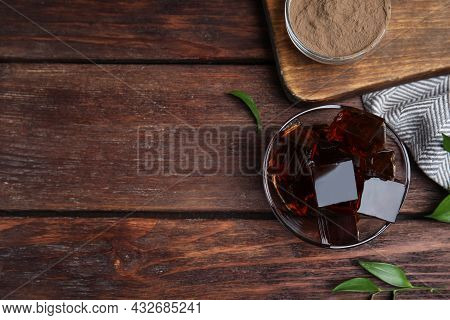 Delicious Grass Jelly Cubes On Wooden Table, Flat Lay. Space For Text