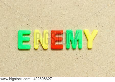 Color Alphabet Letter With Word Enemy On Wood Background