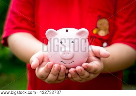 Little Boy Hand Holding Piggy Bank With Copy Space, Saving, Charity, Family Finance Plan Concept, Fu