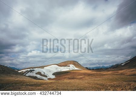 Sunny Mountain Desert Relief With Glacier In Sunlight Under Low Cloudy Sky. Scenic Highlands Landsca
