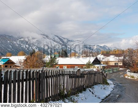 Chemal, Altai Republic, Russia - 15 October 2020: Russian Village Chemal In The Snow. The Road Runs 
