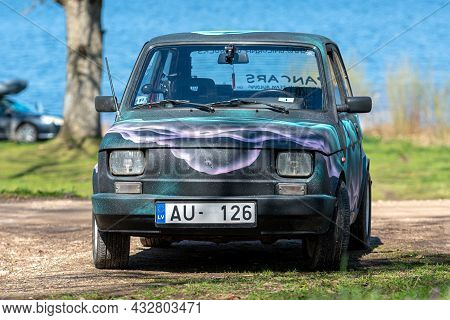Koknese, Latvia - May 01, 2021: Colorful Oldtimer Pancars Rental Car Fiat 126 Parked On The Side Of 