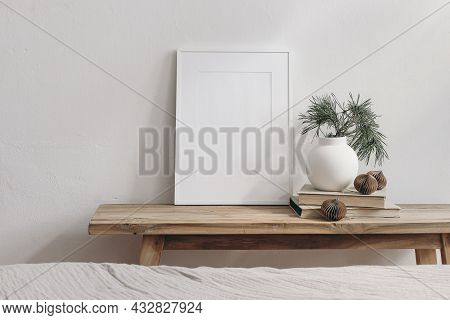 Vertical White Picture Frame Mockup. Vintage Wooden Bench, Table. Modern Vase With Pine Tree Branche