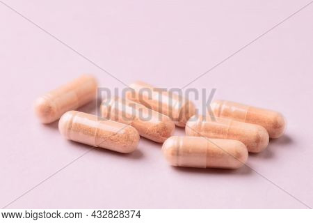 Goji Berry (wolfberry) Capsules. Immune System Support. Dietary Supplement On Pink Paper Background.