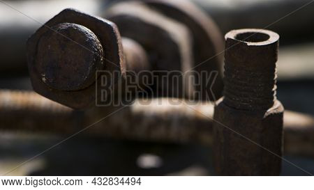 Old Rusty Bolt, Iron Rod With Screw Threads. Rusted Mechanical Components. Threaded Bolt And Nut. Di