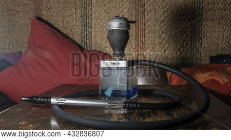 Hookah Square Flask On The Wooden Table. Original Square Designer Hookah.