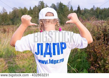 Russia - August 27, 2021. Tver Region. A Girl In A White Cap And A T-shirt With The Inscription \