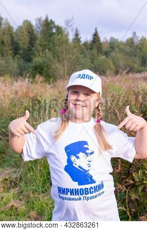 Russia - August 27, 2021. Tver Region. A Girl In A White Cap And A T-shirt With A Photo Of Vladimir 