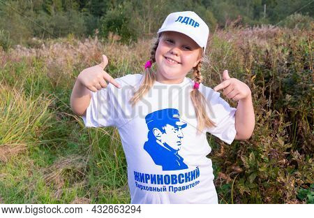 Russia - August 27, 2021. Tver Region. A Girl In A White Cap And A T-shirt With A Photo Of Vladimir 