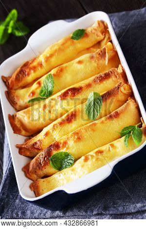 Blintz, Rolled Filled With Sweetened Cottage Cheese Pancakes Or Crepes In A Baking Dish On A Wooden 