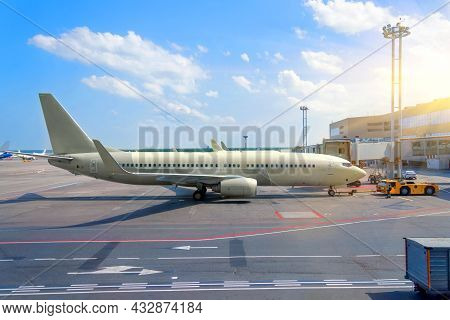 Medium-haul Passenger Aircraft At The Terminal Of The Airport Building In Service Before The Flight