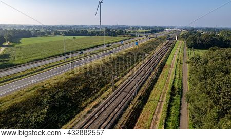 Motorway With Few Cars And Railroad Next To It, Near The Exit Of Brecht In Belgium, Europe. High Qua