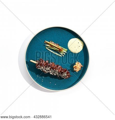 Izakaya food - skewer yakitori with beef and teriyaki sauce. Grilled meat on bamboo stick in Japanese style. Bbq menu for asian restaurant. Yakitori on white background