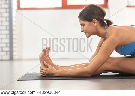 Yogi Woman Doing Stretching In Seated Forward Bend Position, Healthy Life