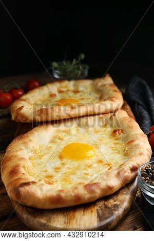 Fresh Delicious Adjarian Khachapuris Served On Wooden Table