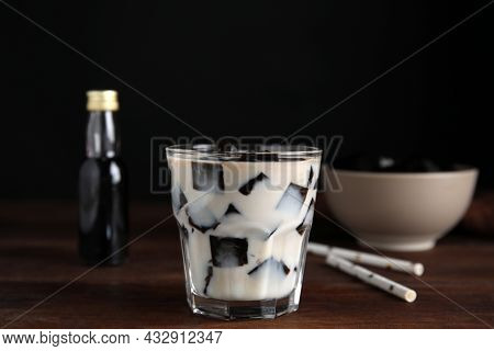 Glass Of Milk With Grass Jelly On Wooden Table