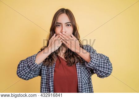 A Beautiful Girl With Long Hair Covering Her Mouth With Both Hands
