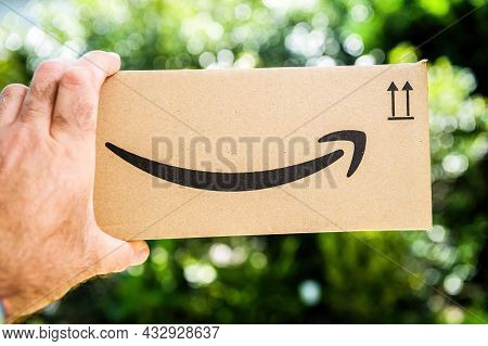 Paris, France - Sep 8, 2021: Pov Personal Perspective Male Hand Holding Amazon Prime Cardboard Packa