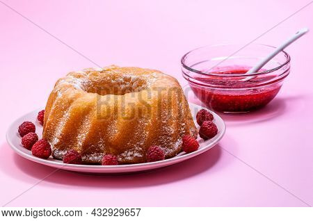 Homemade Kouglof Cake With Icing Sugar Dressing, Raspberries And Raspberry Filling. Gugelhupf, Kugel
