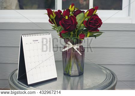 Calendar Desk And Rose Flower On Table. Desktop Calender For Planner To Plan Wedding Agenda, Timetab
