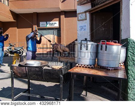 Nabon, Ecuador - September 5, 2021: Man Prepares Chancho Hornado Or Roasted Pig Which Is Typical Ecu