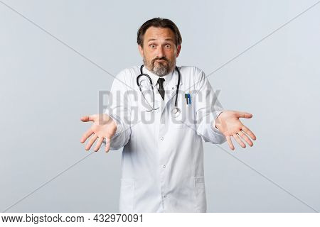 Covid-19, Coronavirus Outbreak, Healthcare Workers And Pandemic Concept. Confused Worried Male Docto