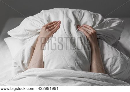 Woman In Bed Hiding Face Under Pillow