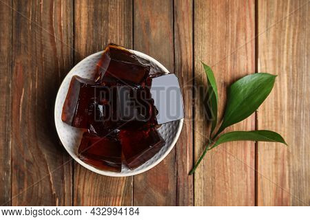 Delicious Grass Jelly Cubes On Wooden Table, Flat Lay