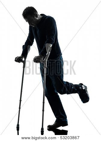 one  man injured man walking with crutches in silhouette studio  on white background