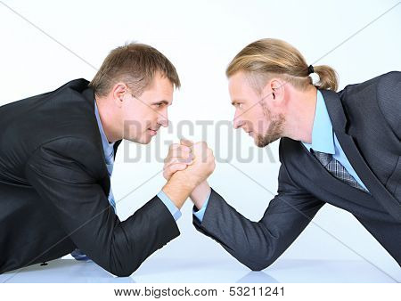 Arm wrestling of business people isolated on white