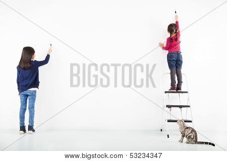 Two Kids Drawing On The Blank White Wall