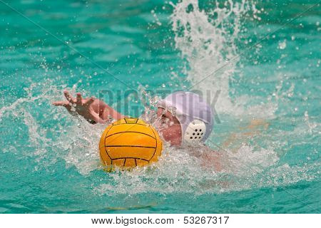 Water polo player swimming for the ball
