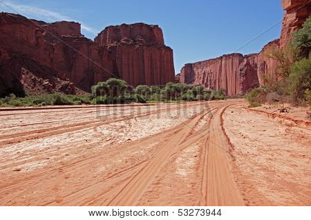 Dry riverbed and steep sandstone cliffs in the Talampaya National Park, La Rioja, Argentina