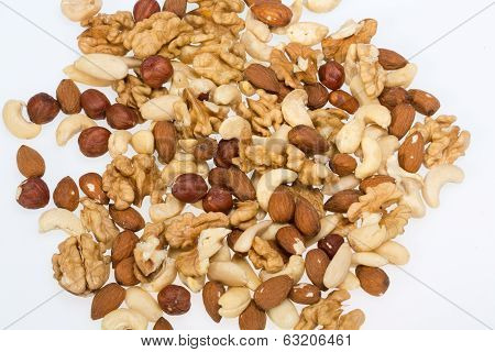 mixed nuts - hazelnuts walnuts cashews pine nuts isolated on white background
