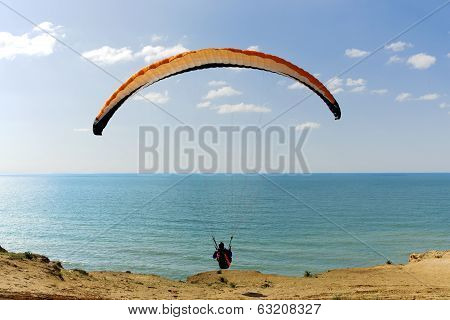Paraglider flying above Mediterranean