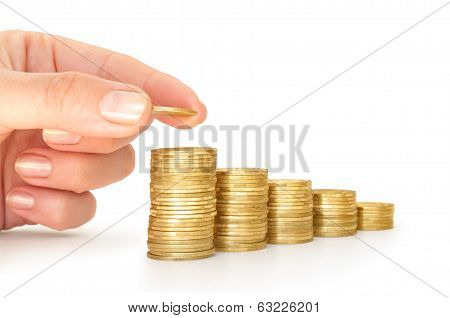 stacks of coins like diagram with reflection and hand put coins